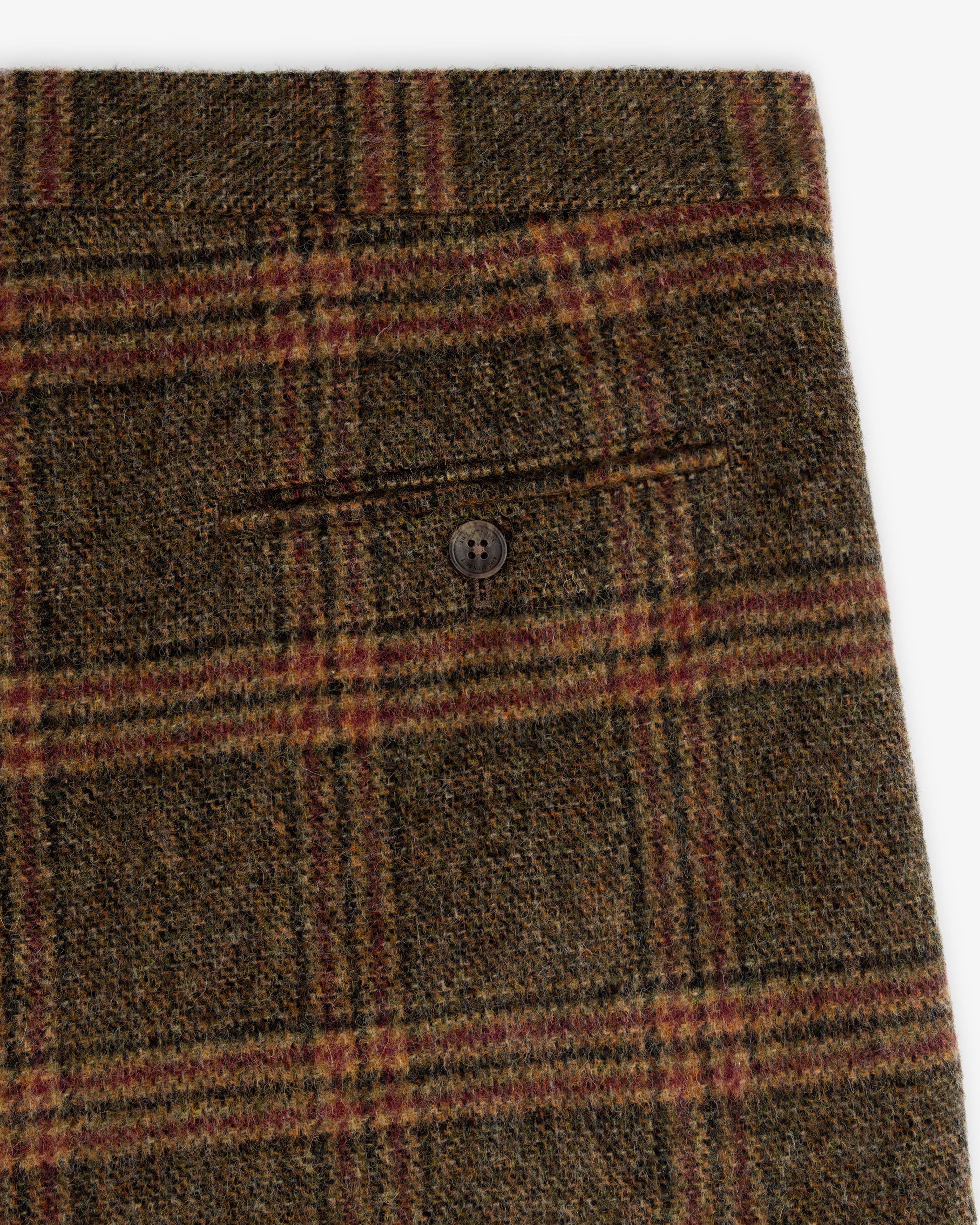 Close-up of olive green Plaid Tweed Suit Trouser featuring a single buttoned back pocket.