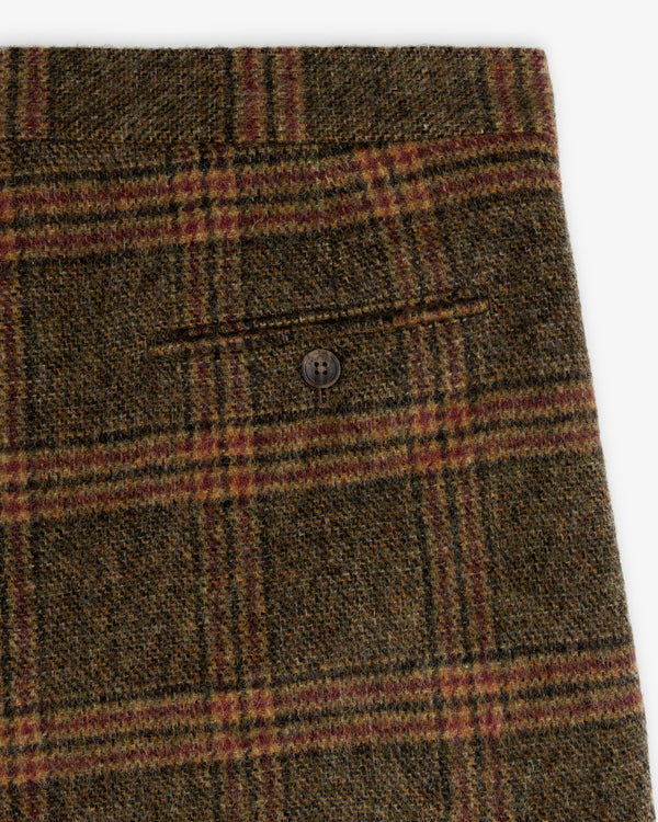 Close-up of olive green Plaid Tweed Suit Trouser featuring a single buttoned back pocket.