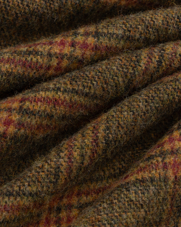 Close-up of thick, textured wool Plaid Tweed Suit Trouser fabric with a multicolored plaid pattern.