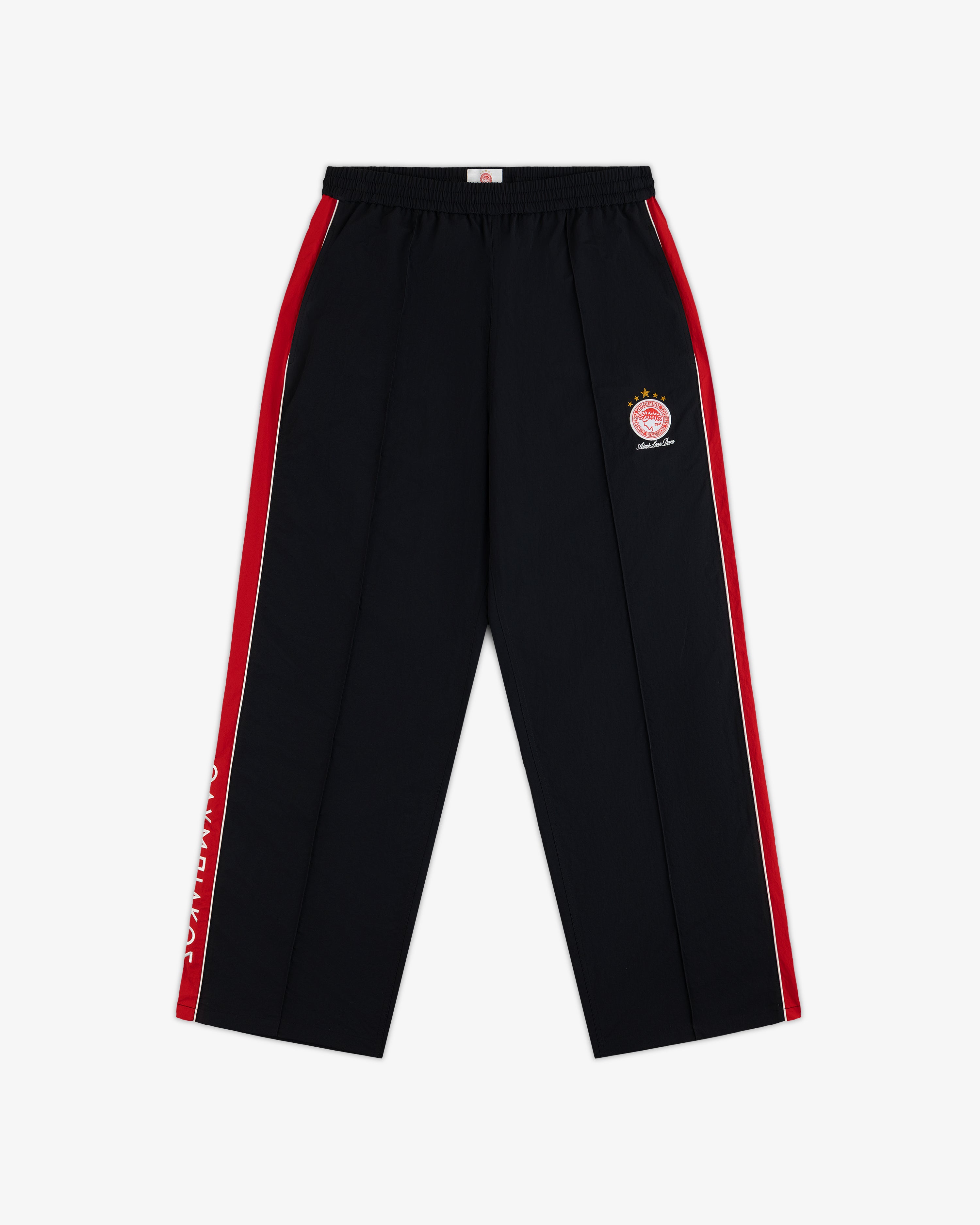 ALD / Olympiacos F.C. Nylon Track Pant in black with red and white side stripes, a circular sports emblem, and leg text.