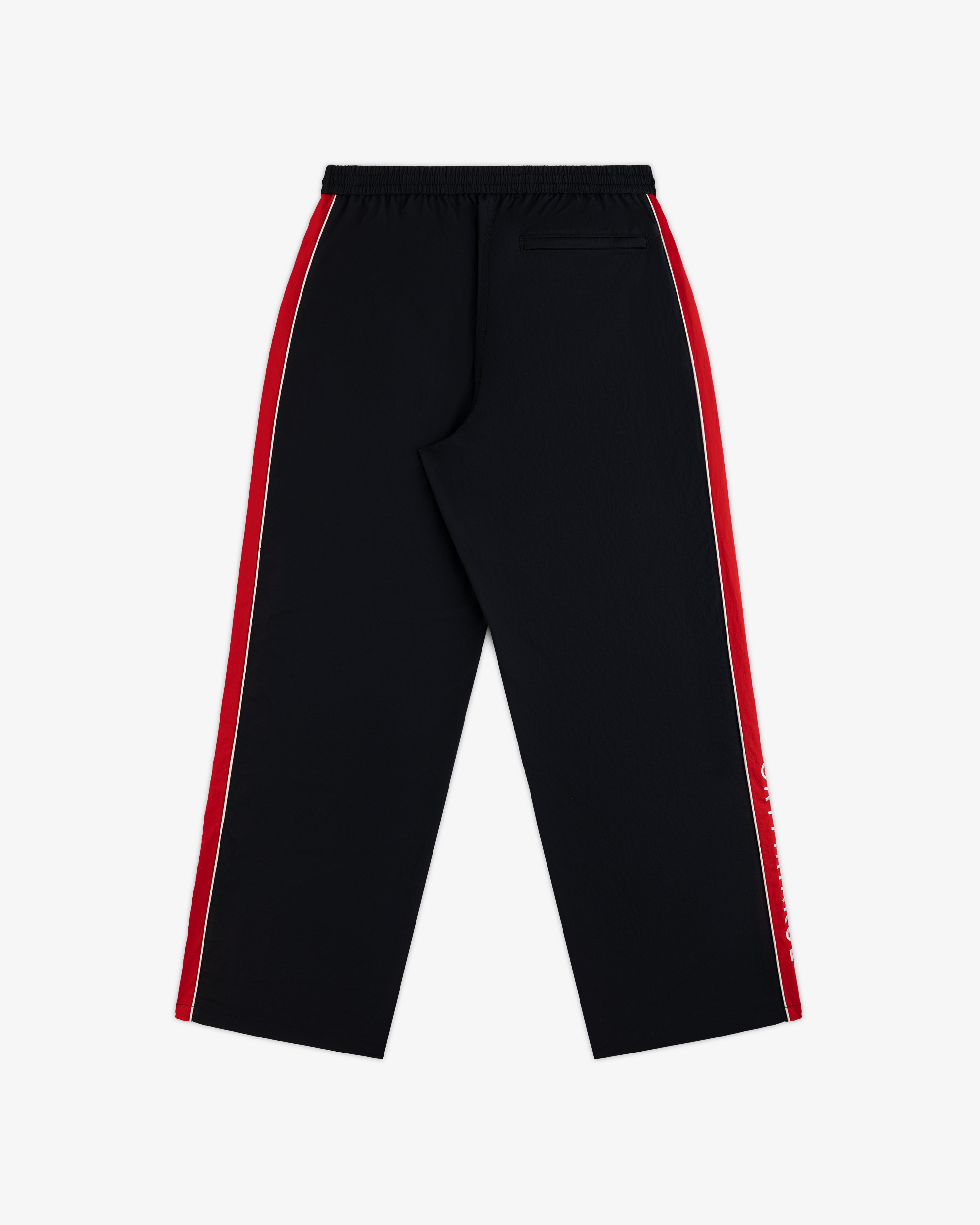 Back view of black ALD / Olympiacos F.C. Nylon Track Pant with red and white stripes down the sides.