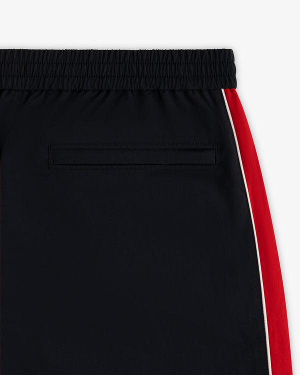 ALD / Olympiacos F.C. Nylon Track Pant in black with a dark waistband, side pocket, and red and white side stripes.
