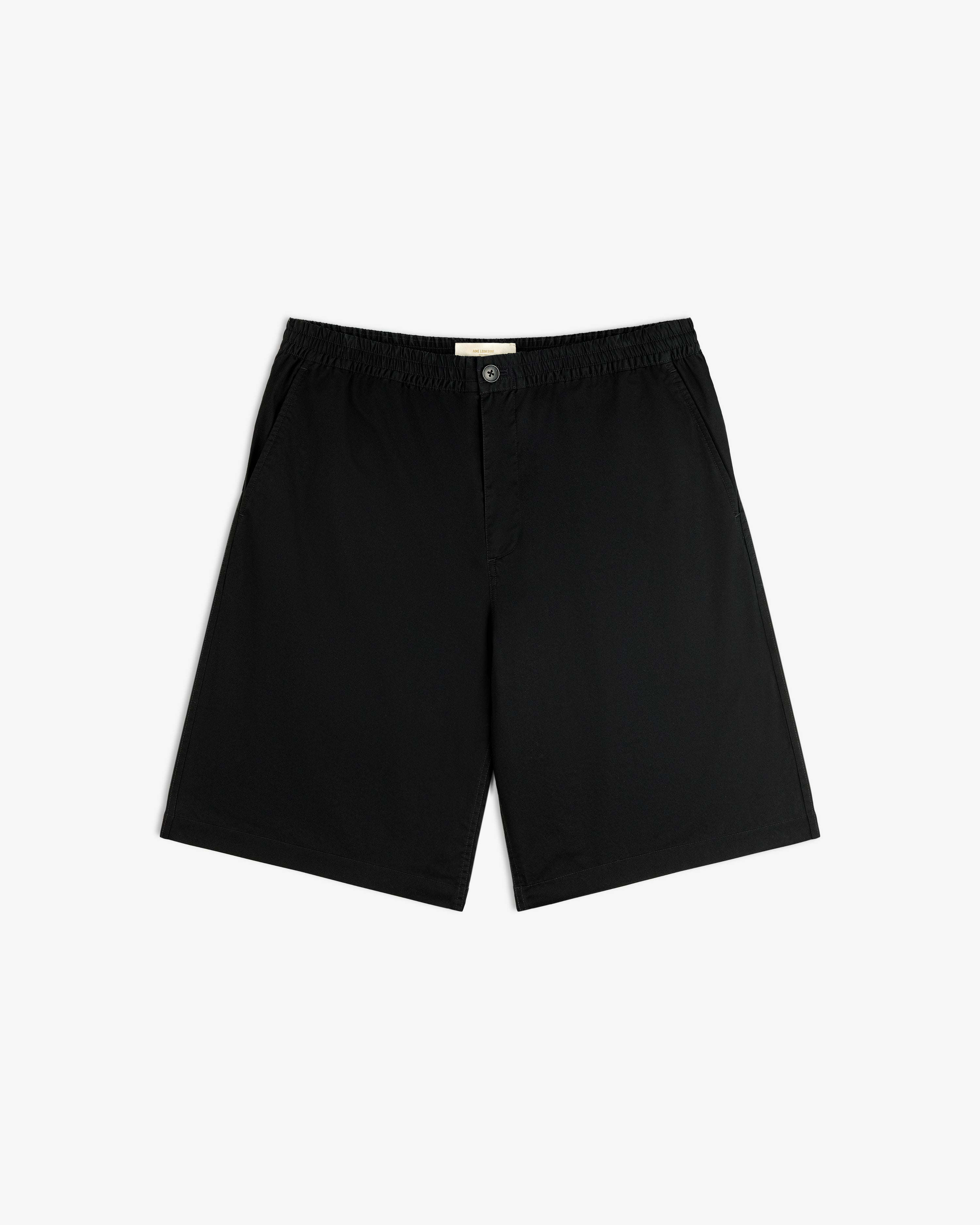 Cotton Casual Short: black, knee-length, elastic waistband, side pockets, button closure, laid flat on white.