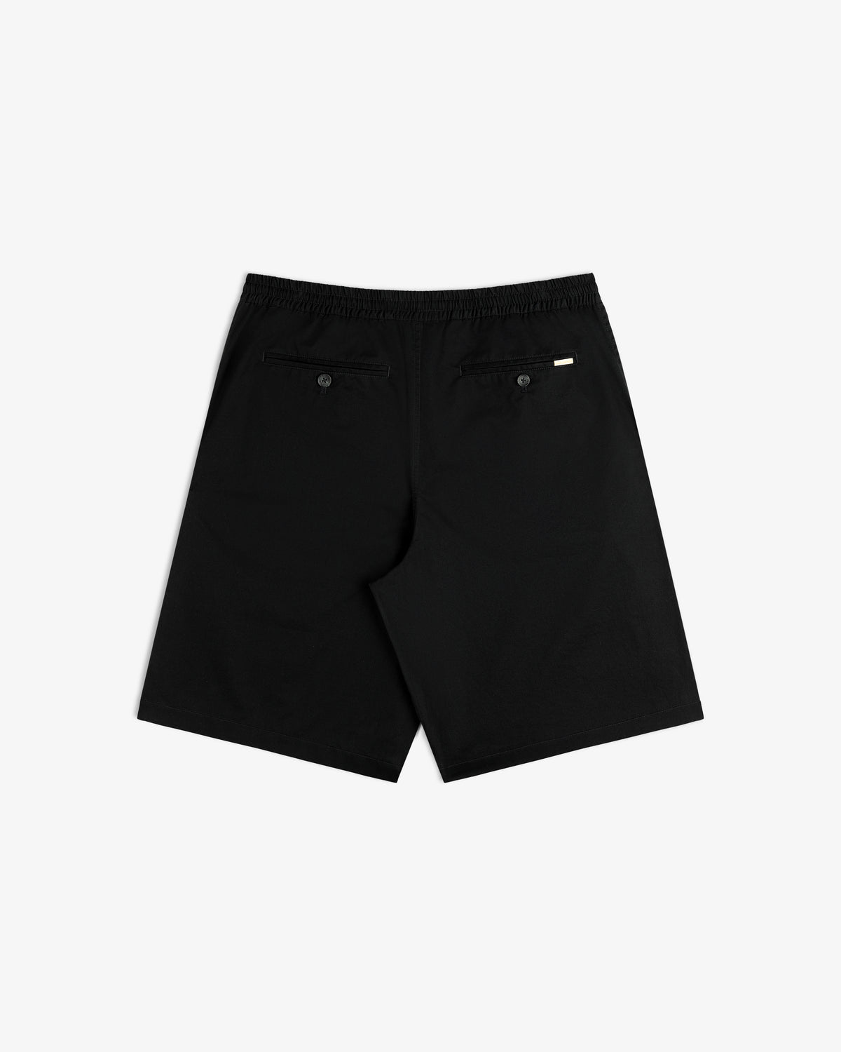 The Cotton Casual Short in black is shown from the back with two buttoned pockets and a right-side tag.