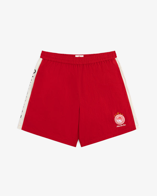 ALD / Olympiacos F.C. Nylon Training Short: red nylon athletic shorts with white side stripes and a team logo.