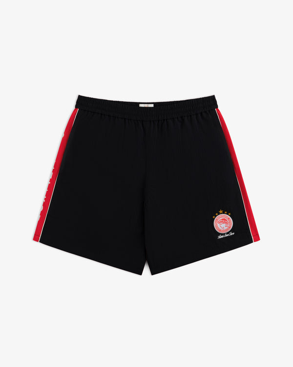 ALD / Olympiacos F.C. Nylon Training Short: black athletic shorts with red side stripes and a front right team emblem.