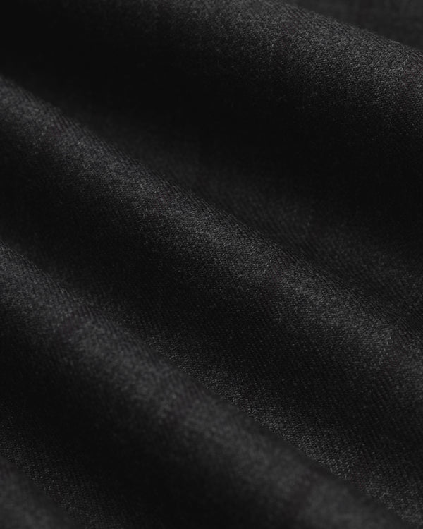 Close-up of the Striped Tailored Maxi Skirt, showing black fabric with subtle vertical stripes and soft folds.