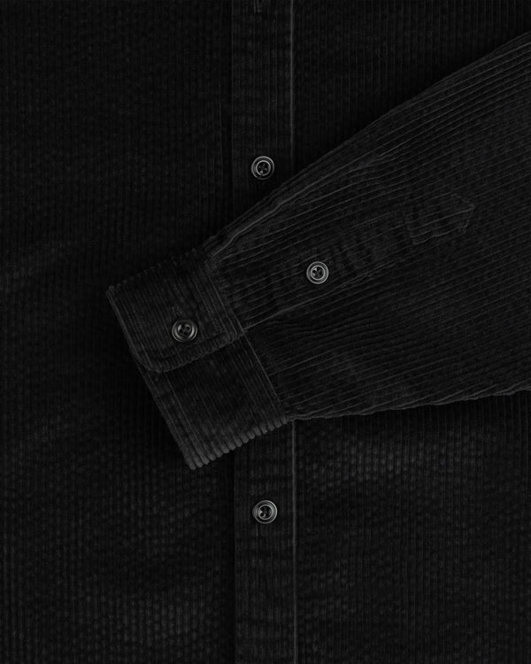 Black Corduroy Leon Overshirt sleeve showing the buttoned cuff and placket.