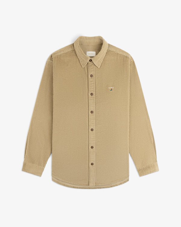 Beige Corduroy Leon Overshirt with a button-down front, long sleeves, and a small embroidered chest graphic.