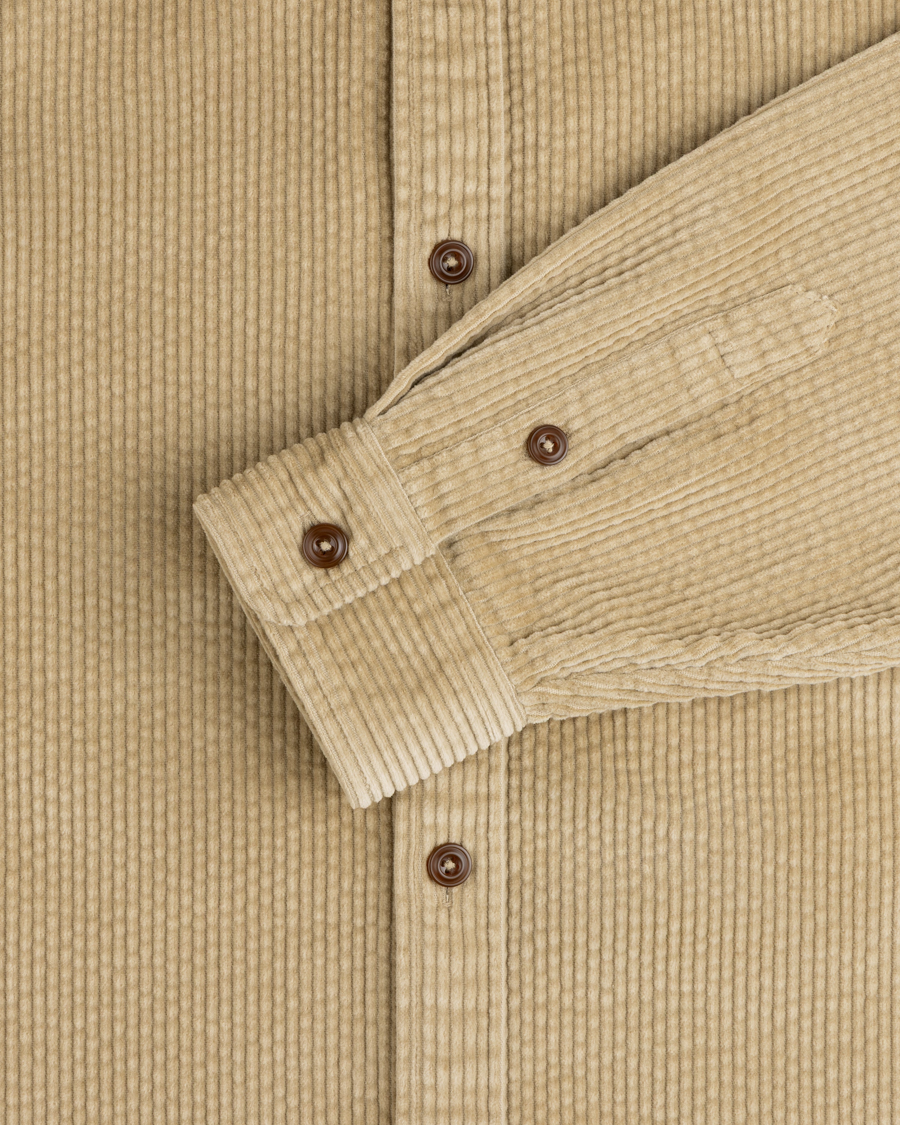 Corduroy Leon Overshirt in tan with brown buttons and a buttoned cuff.