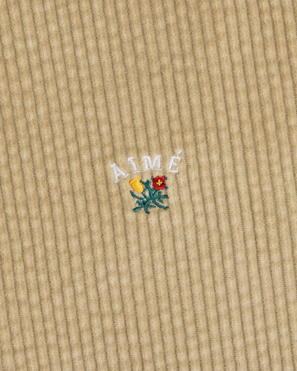 Corduroy Leon Overshirt in tan corduroy with white embroidered Aime text above a small floral design.