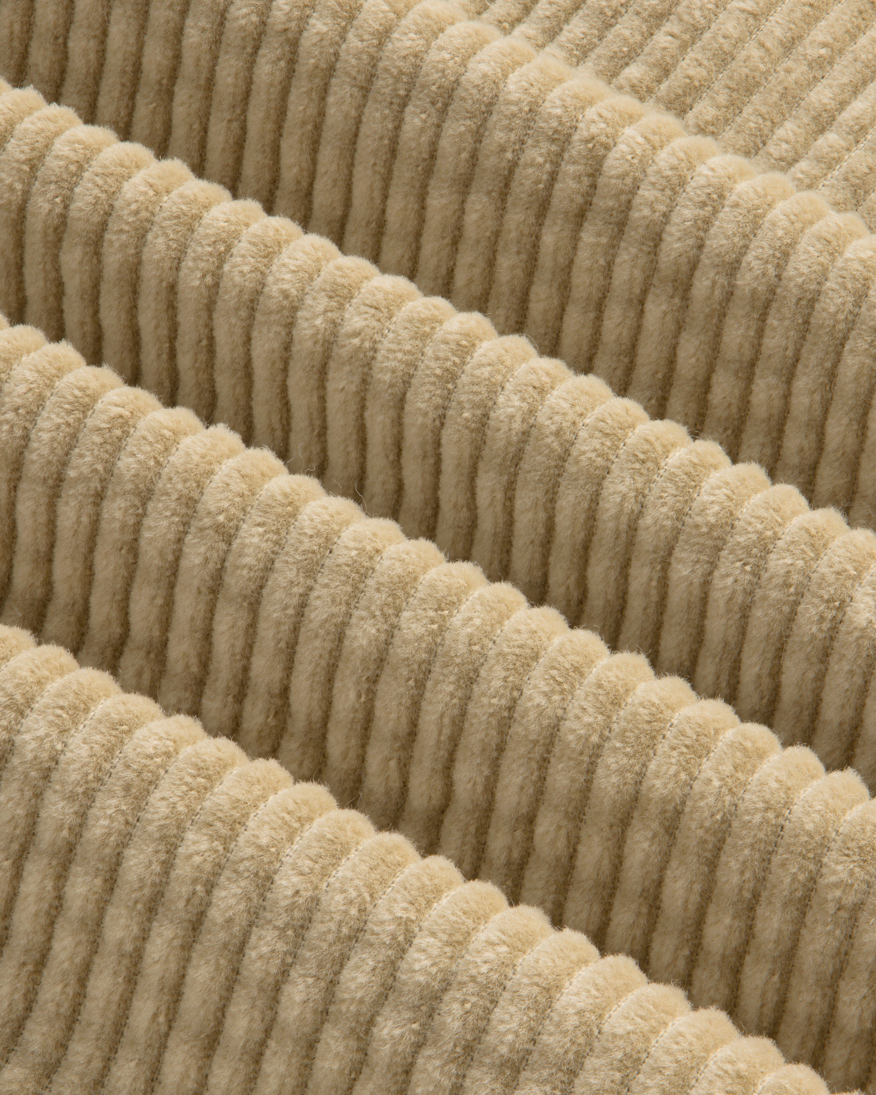 Close-up of the beige Corduroy Leon Overshirt, featuring wide, raised vertical wales in the fabric.