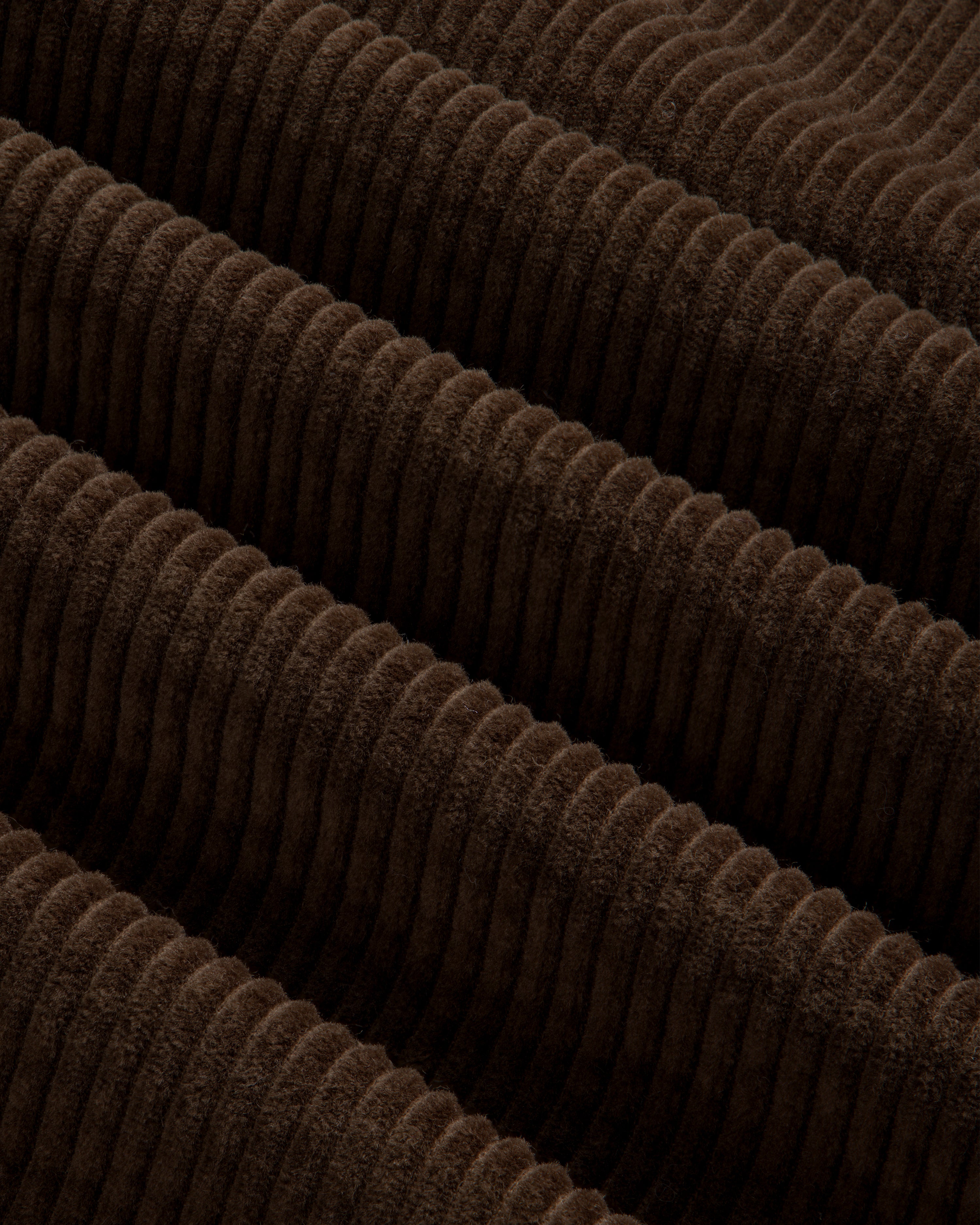 Close-up of brown Quarter Zip Corduroy Shirt fabric with wide, raised vertical wales.