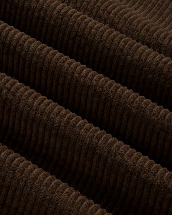 Close-up of brown Quarter Zip Corduroy Shirt fabric with wide, raised vertical wales.