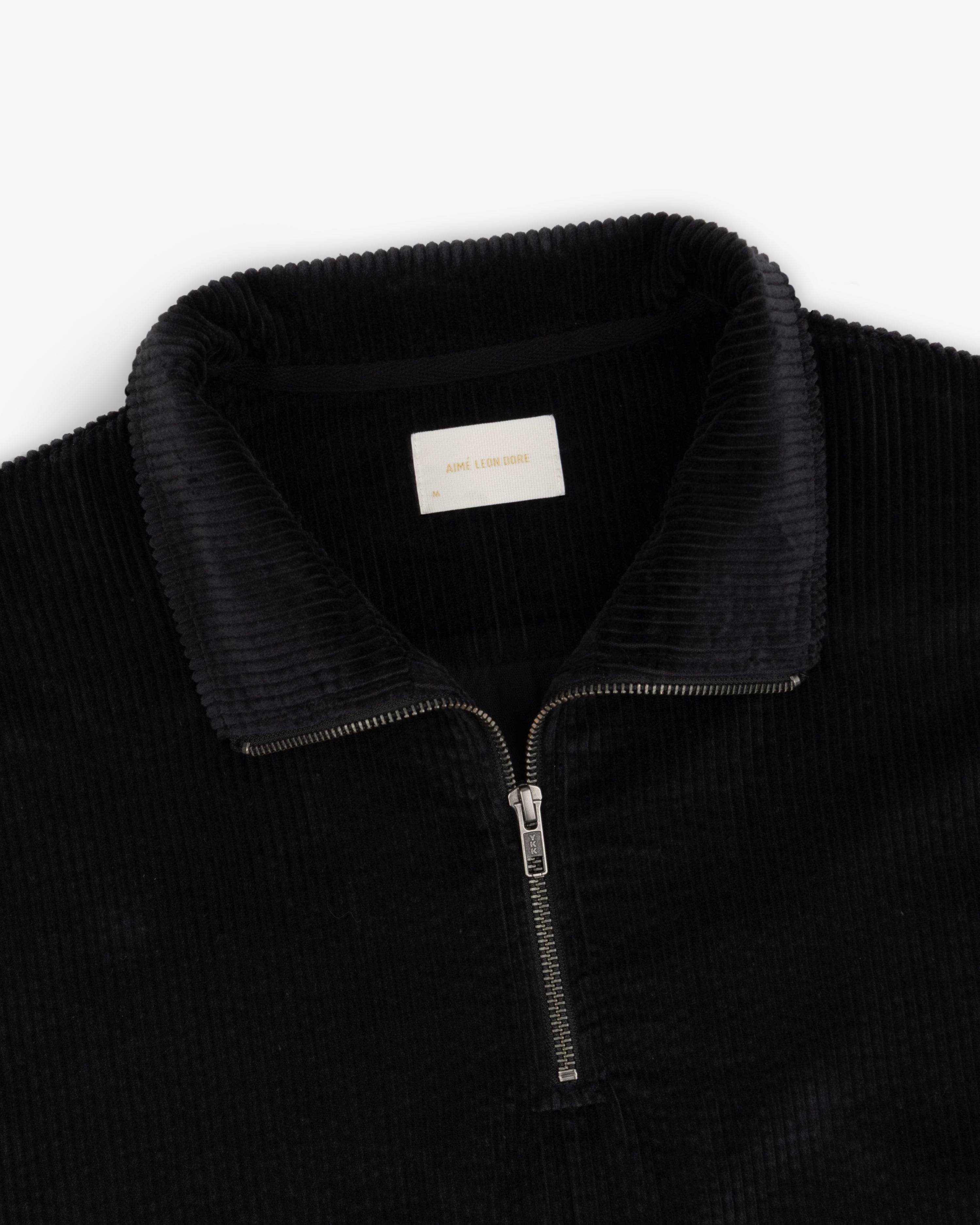 Black Quarter Zip Corduroy Shirt with a silver zipper and collared neckline.