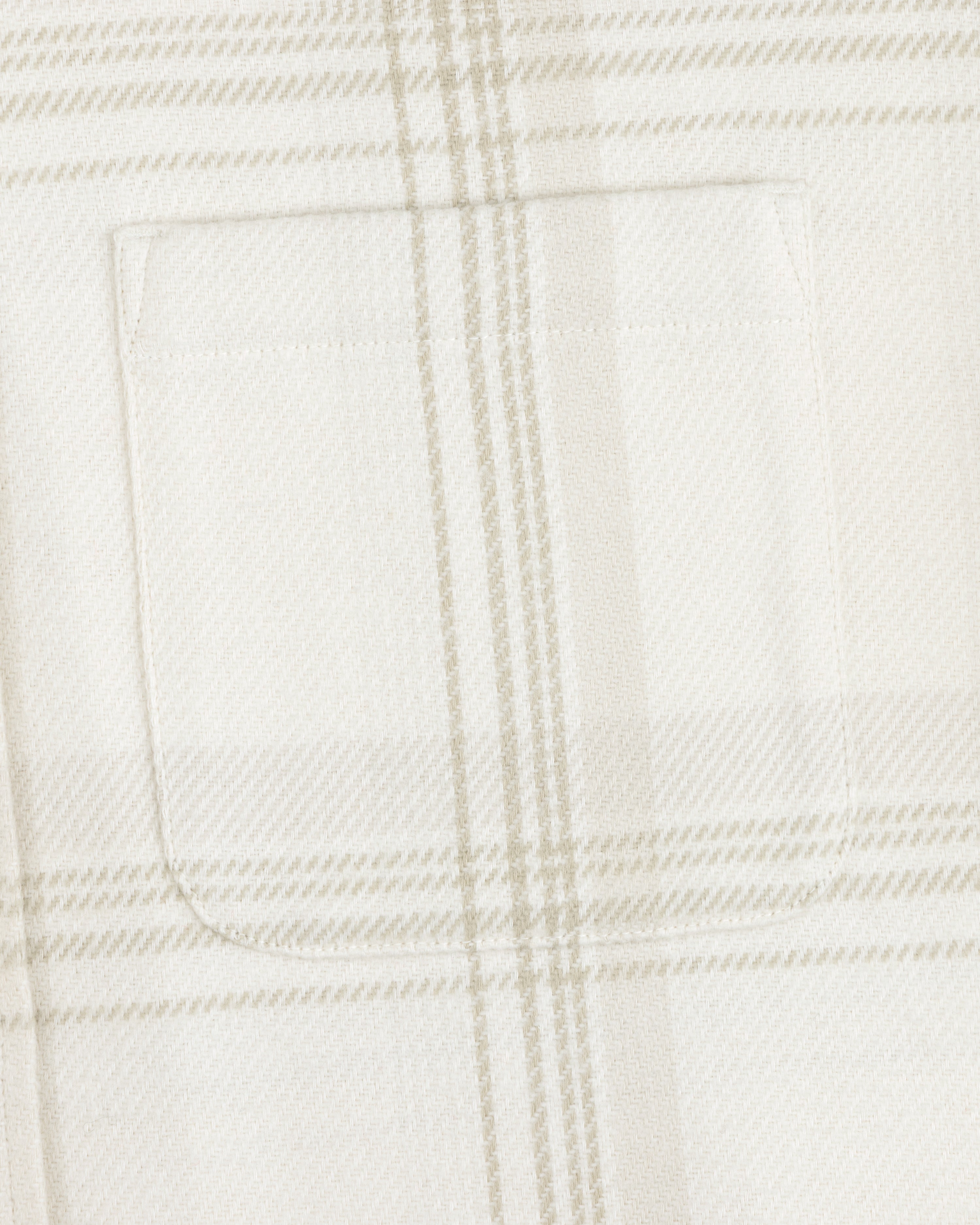 Close-up of a chest pocket on a cream and tan Yarn Dyed Plaid Overshirt.