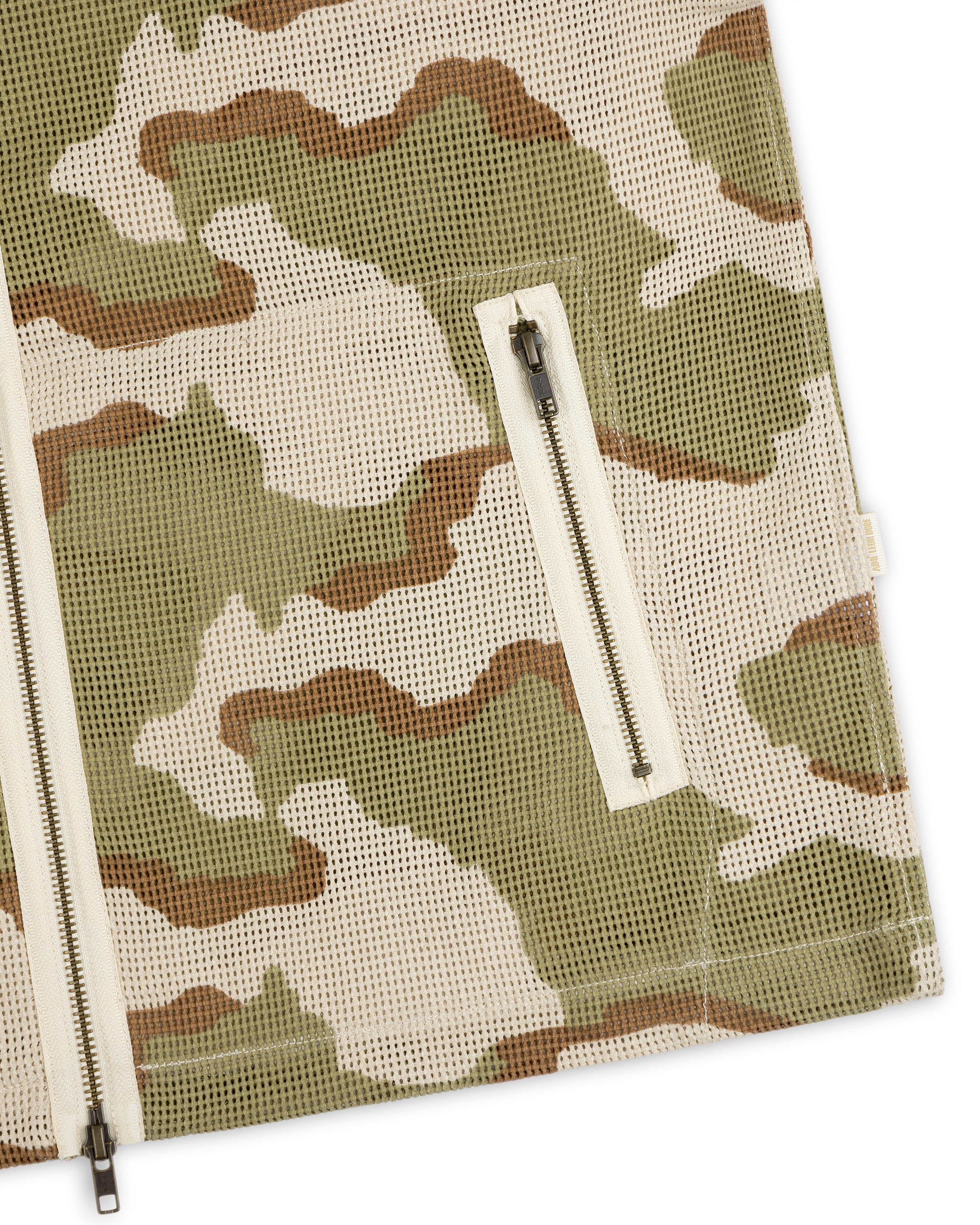 Camo Mesh Zip Overshirt featuring a camo-patterned mesh design, central full-length zipper, and side zippered pocket.