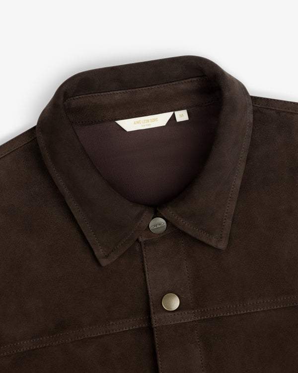 Close-up of a dark brown Suede Overshirt with a classic collar and metal snap buttons.
