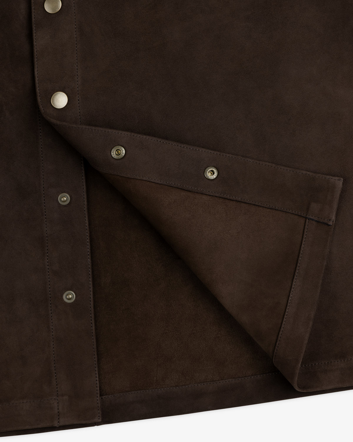 Close-up of a dark brown Suede Overshirt with silver snap buttons.