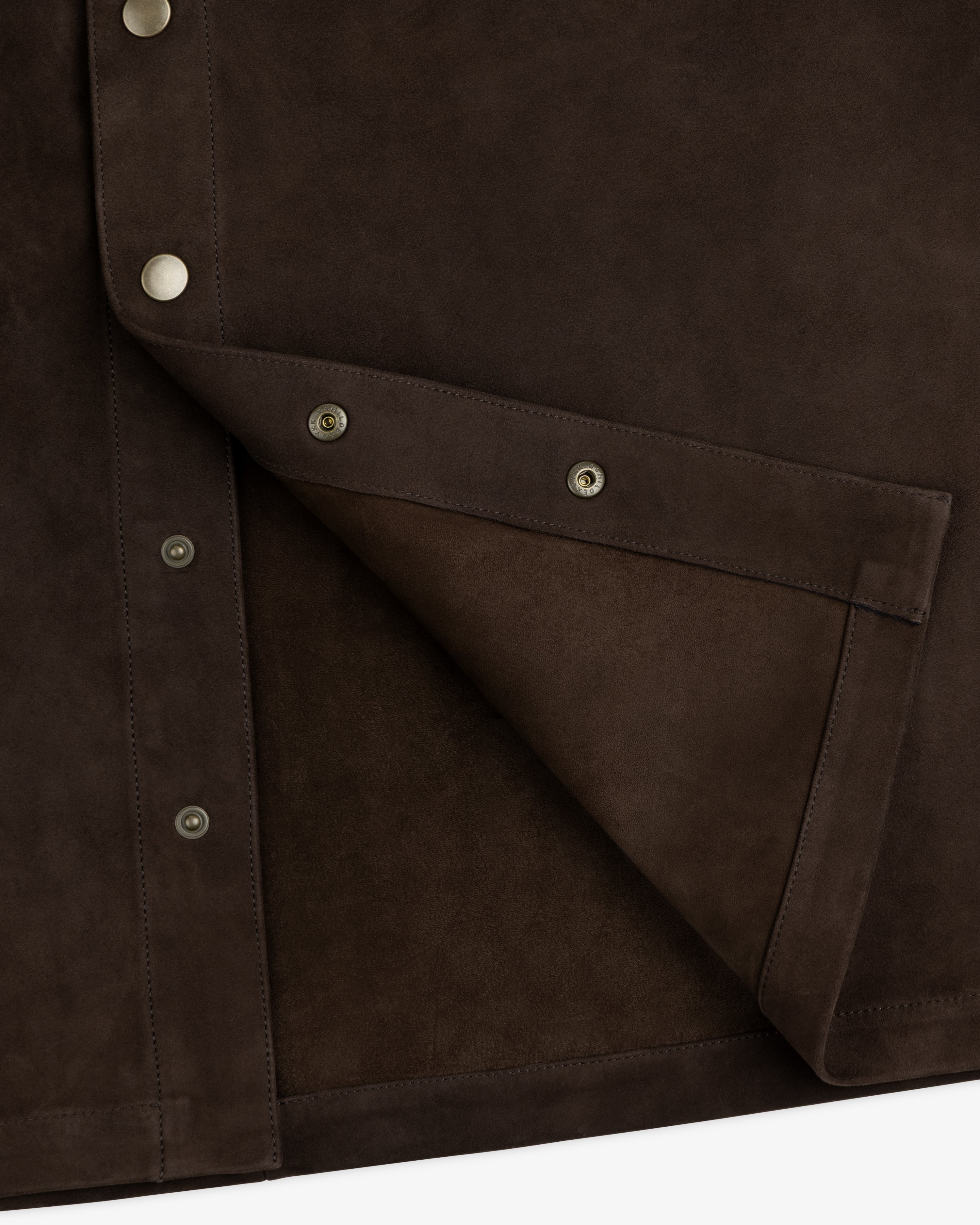 Close-up of a dark brown Suede Overshirt with silver snap buttons.