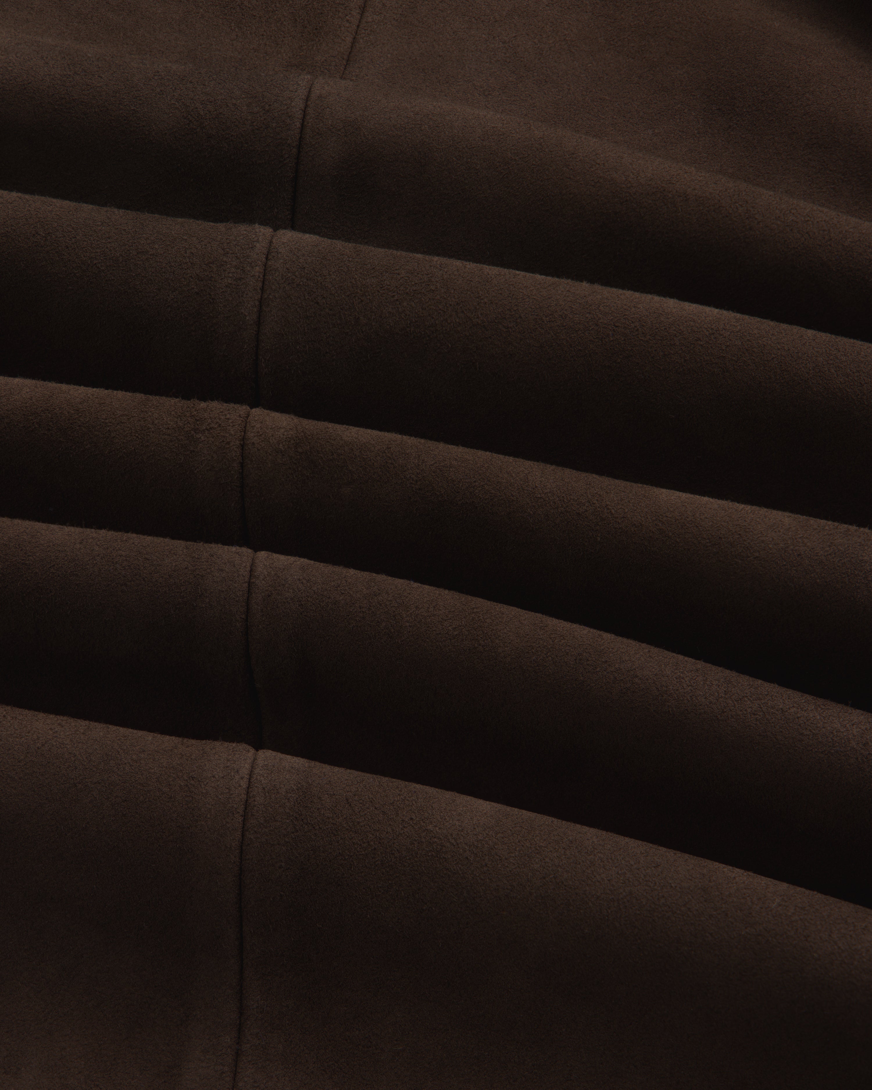 Close-up of the dark brown suede Suede Overshirt featuring horizontal seamed folds.