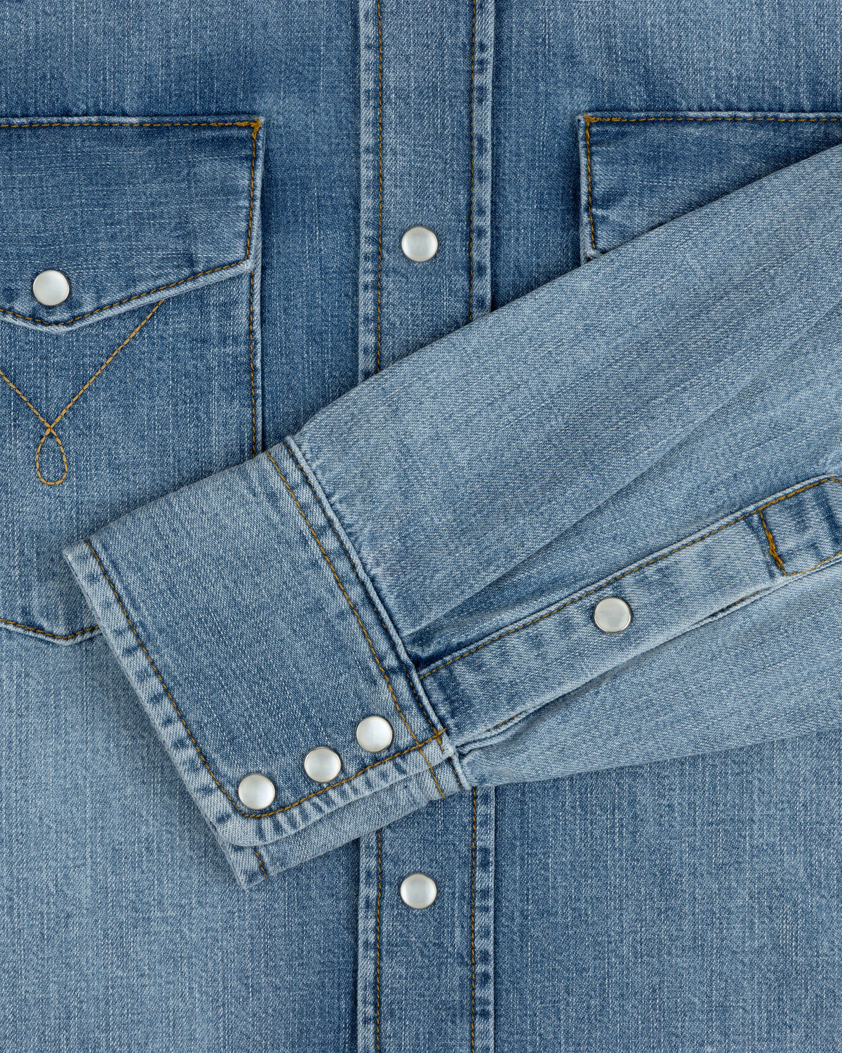 Denim Western Shirt in blue with silver snap buttons, chest pockets, and buttoned cuffs.