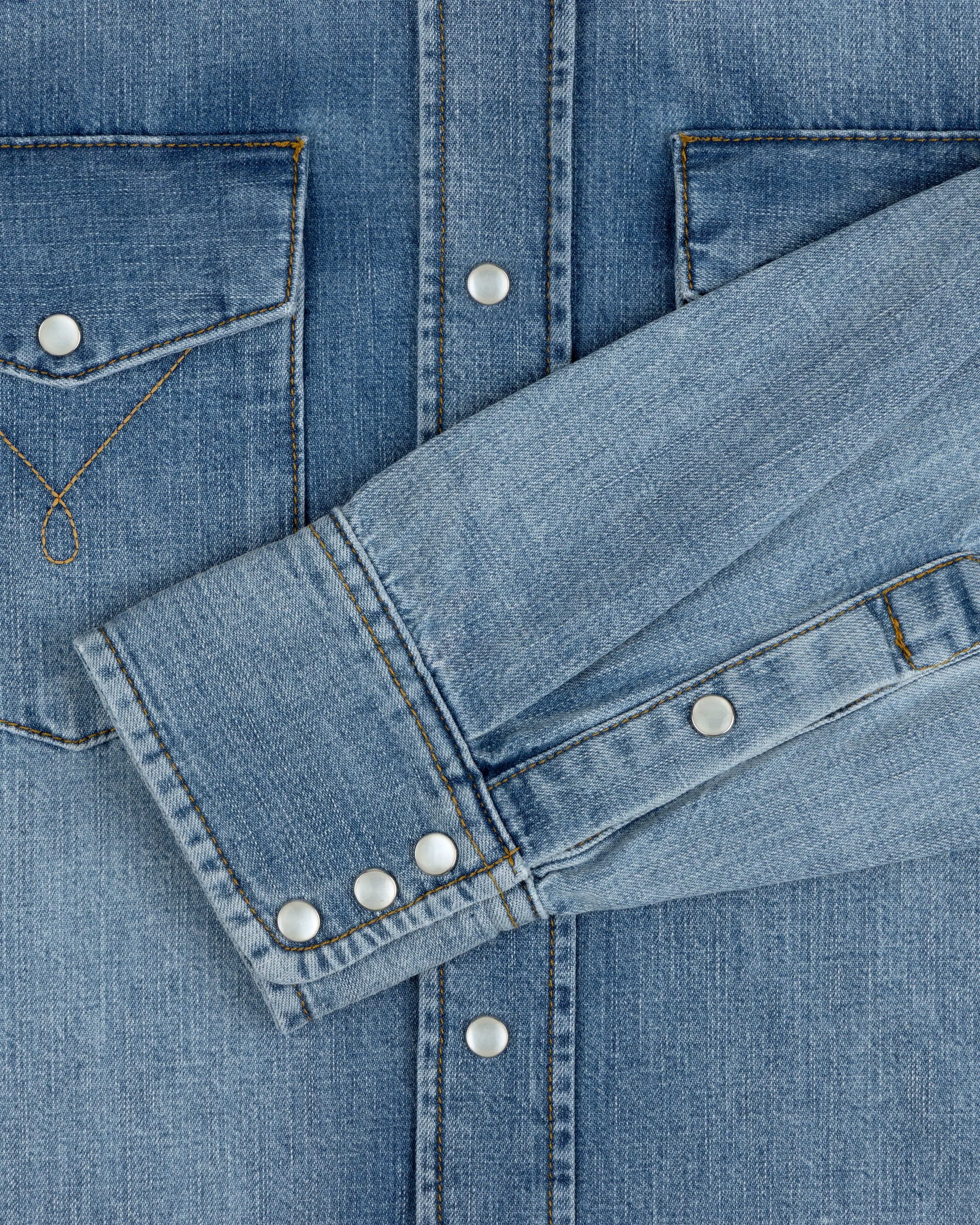 Denim Western Shirt in blue with silver snap buttons, chest pockets, and buttoned cuffs.