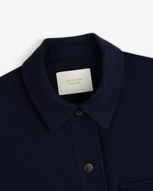 Mani Embroidered Wool Jacket in navy blue with a collar, button front, and white brand label at the neckline.
