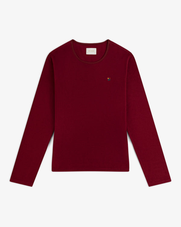 Crest Long-Sleeve Fleece Tee in deep red with a small embroidered emblem on the chest.