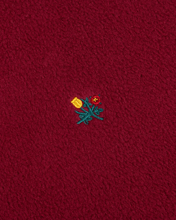 Crest Long-Sleeve Fleece Tee in maroon, featuring an embroidered red flower and yellow tulip detail.