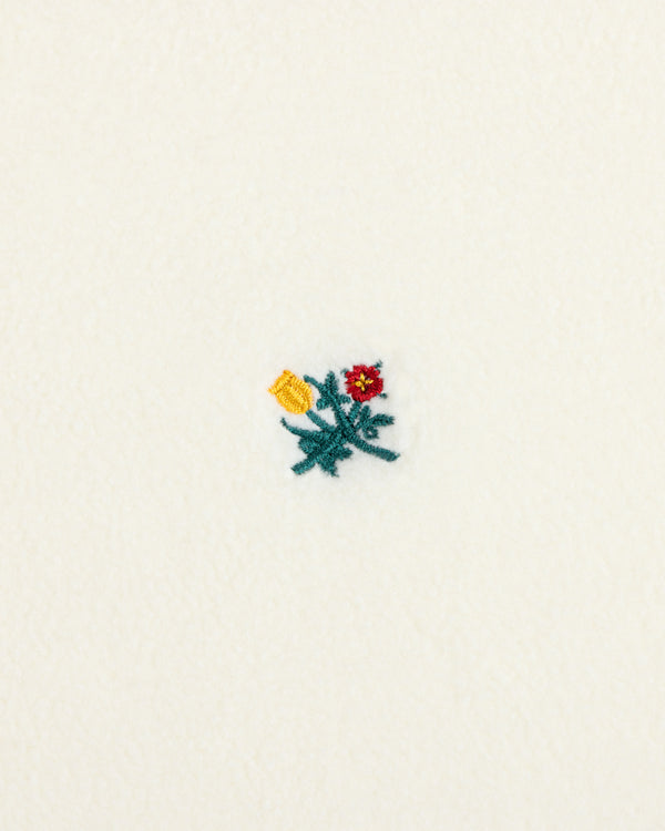 Crest Long-Sleeve Fleece Tee in off-white featuring an embroidered cluster of a yellow flower, red flower, and green leaves.