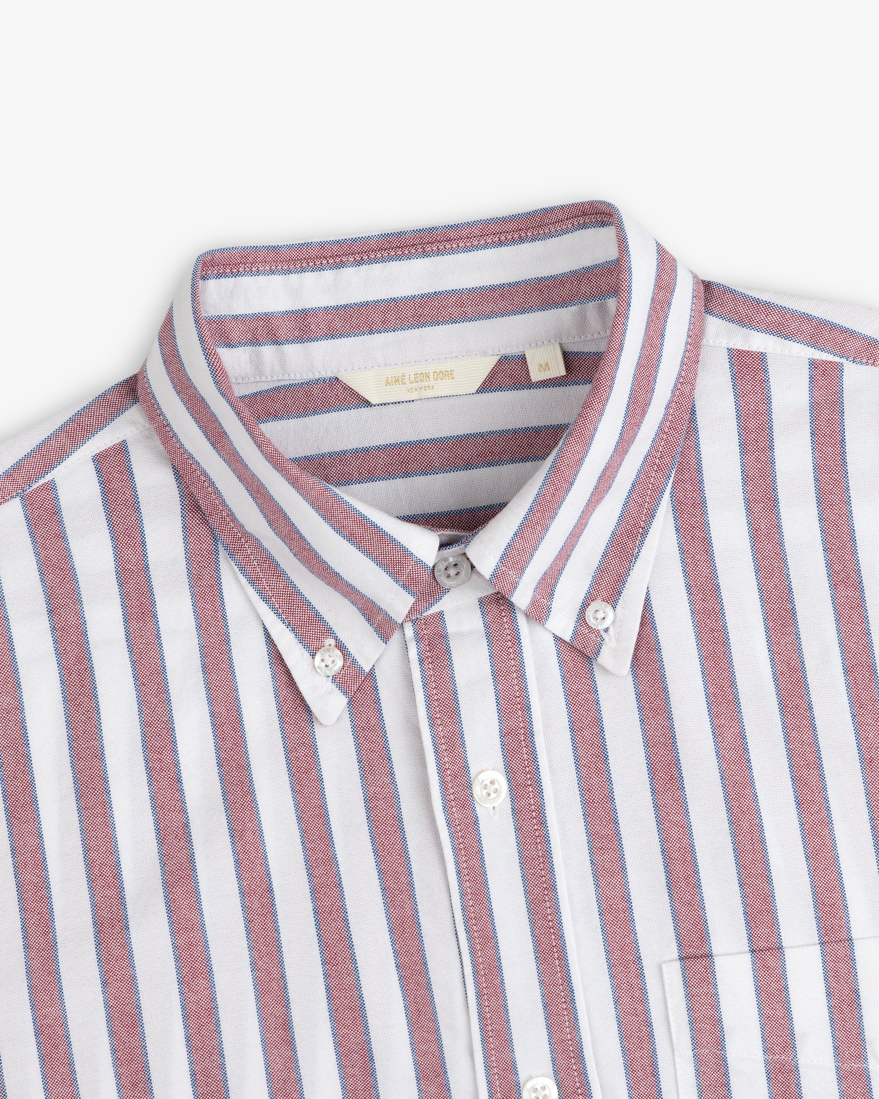 Striped Crest Oxford Shirt: White, button-down with red & blue vertical stripes, collar, and chest pocket.
