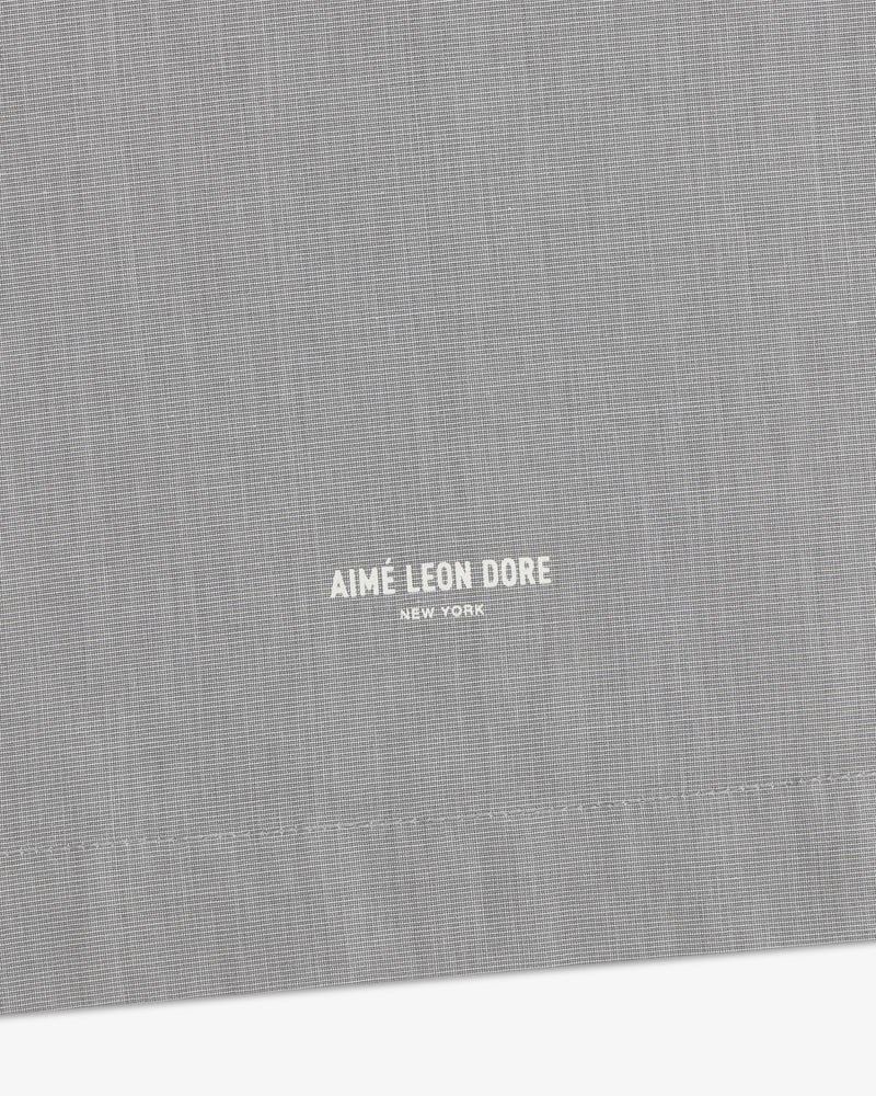 Close-up of gray Poplin Casual Shirt featuring small white Aimé Leon Dore New York text near the bottom center.
