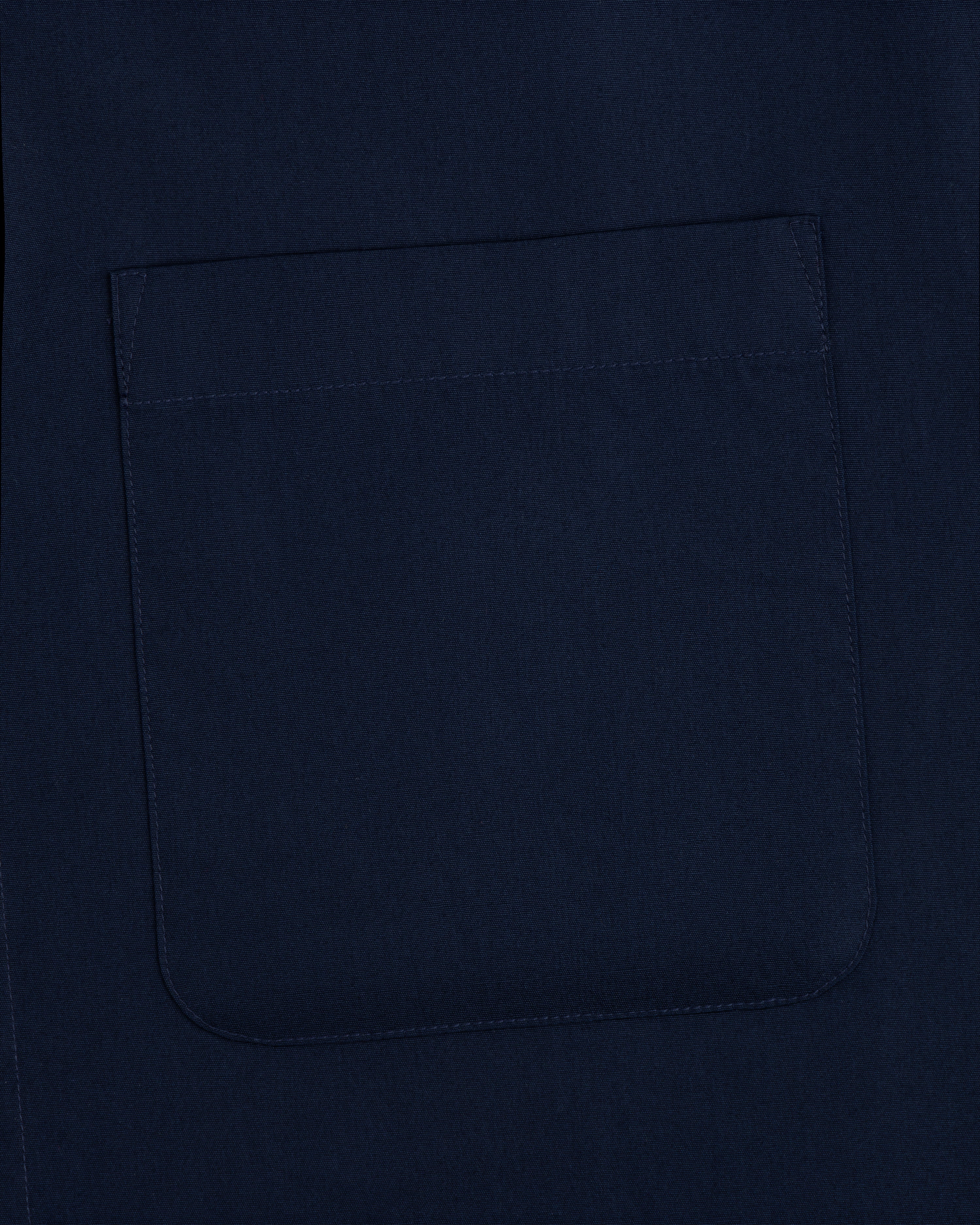 A close-up of a square, navy pocket sewn onto matching Poplin Casual Shirt fabric.