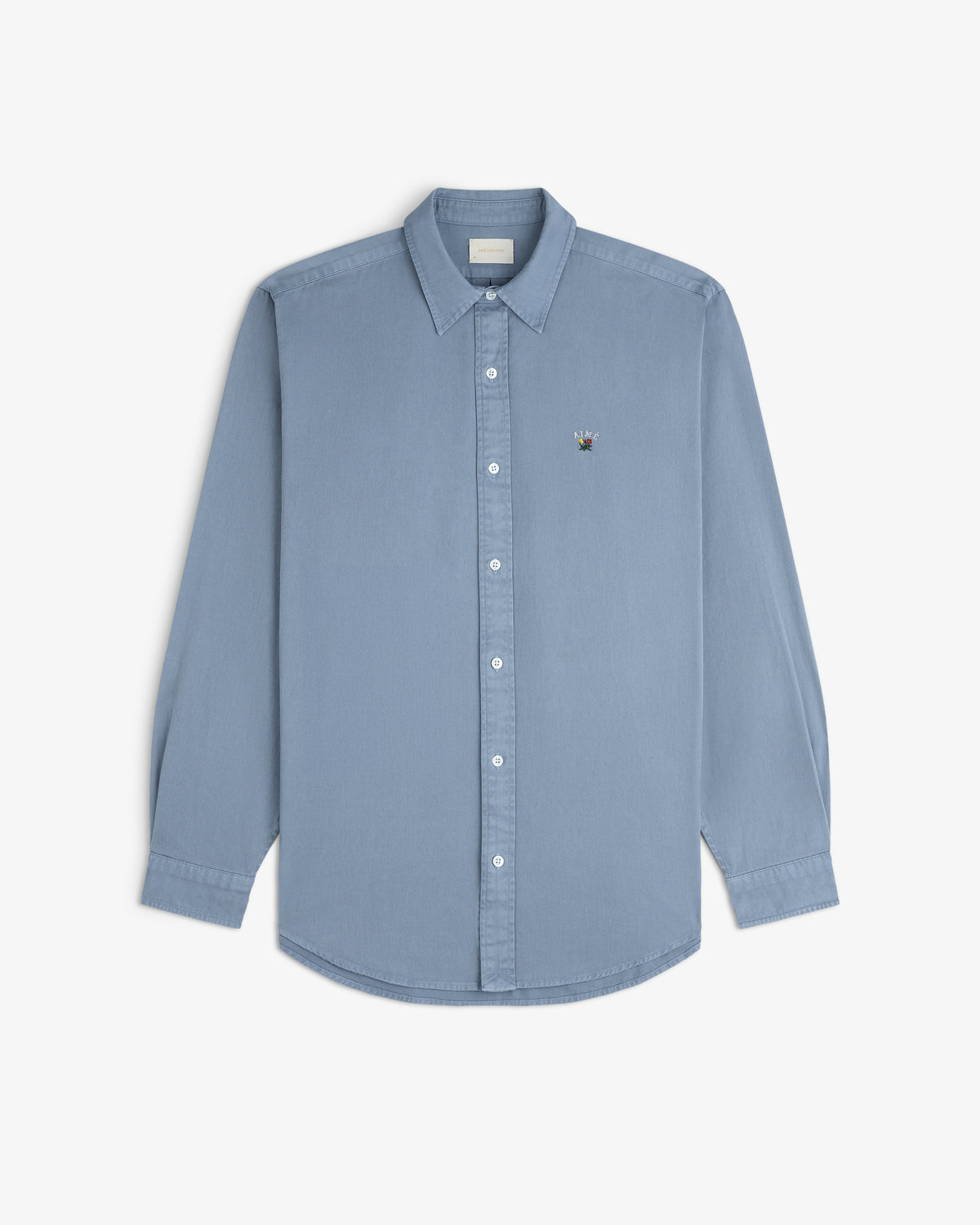 Garment Dyed Leon Overshirt in light blue, long sleeves, button-down, with embroidered crest on left chest.