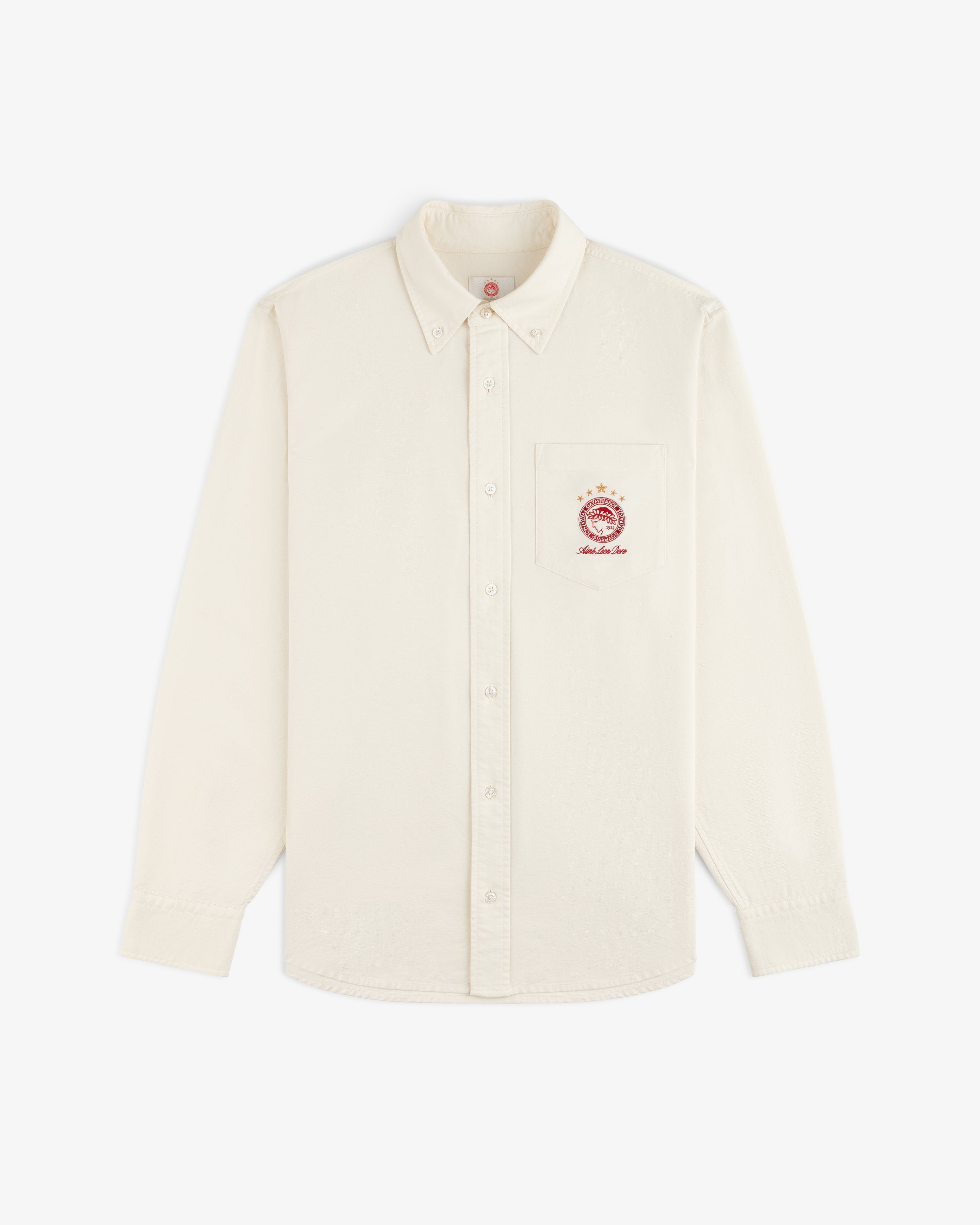 ALD / Olympiacos F.C. Logo Oxford Shirt: off-white long-sleeve button-down with a sports crest on the chest pocket.
