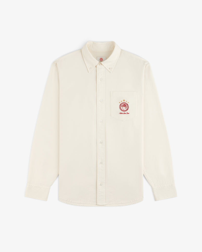 ALD / Olympiacos F.C. Logo Oxford Shirt: off-white long-sleeve button-down with a sports crest on the chest pocket.