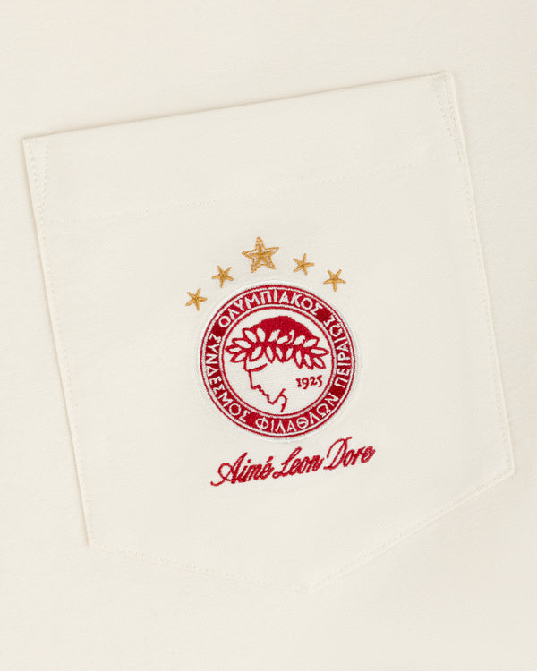 An ALD / Olympiacos F.C. Logo Oxford Shirt pocket with an embroidered crest featuring a laurel-crowned profile and stars.