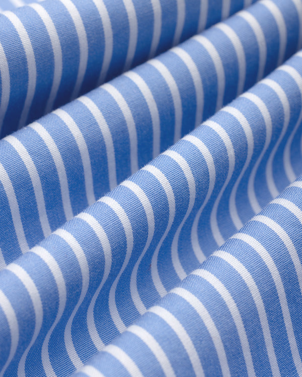 Blue and white vertically striped fabric with soft folds of a Striped Button Down Poplin Shirt.