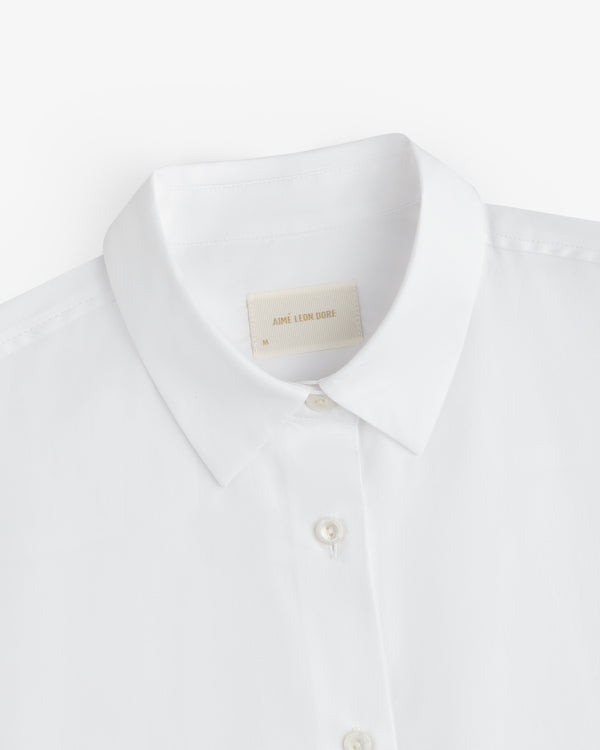 White Button Down Poplin Shirt collar with a size medium tag at the neckline.