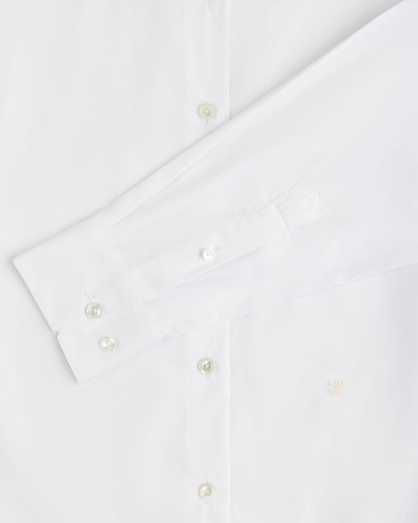 Close-up of a white Button Down Poplin Shirt featuring a barrel cuff with two buttons and a small embroidered logo.