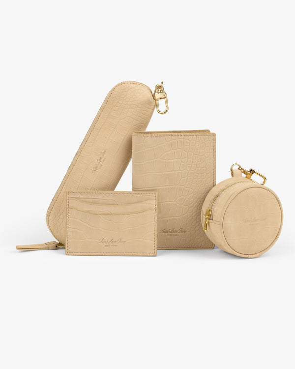 Croc-embossed nubuck keychain pouch in beige—perfect for storing coins or small accessories.