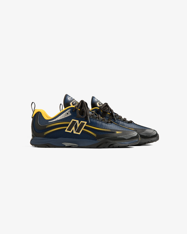 The ALD / New Balance RC56 sneakers feature navy and yellow uppers, black soles, and a bold N logo on the sides.