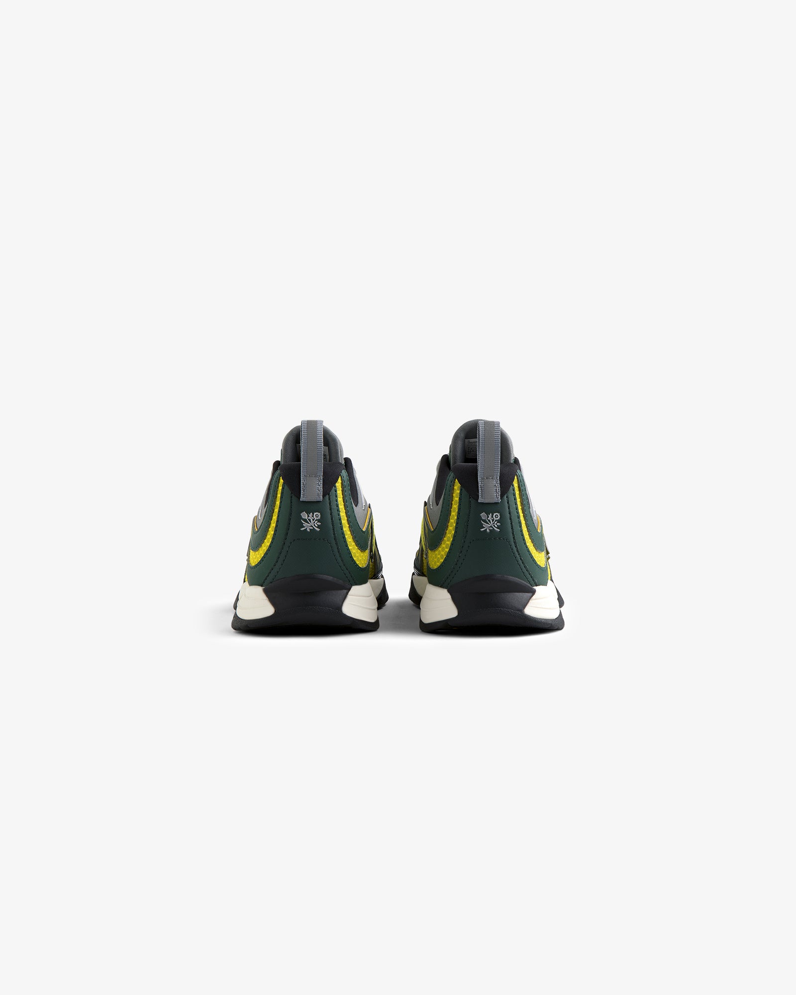 The ALD / New Balance RC56 sneakers in green and yellow, shown from the back on a plain white background.