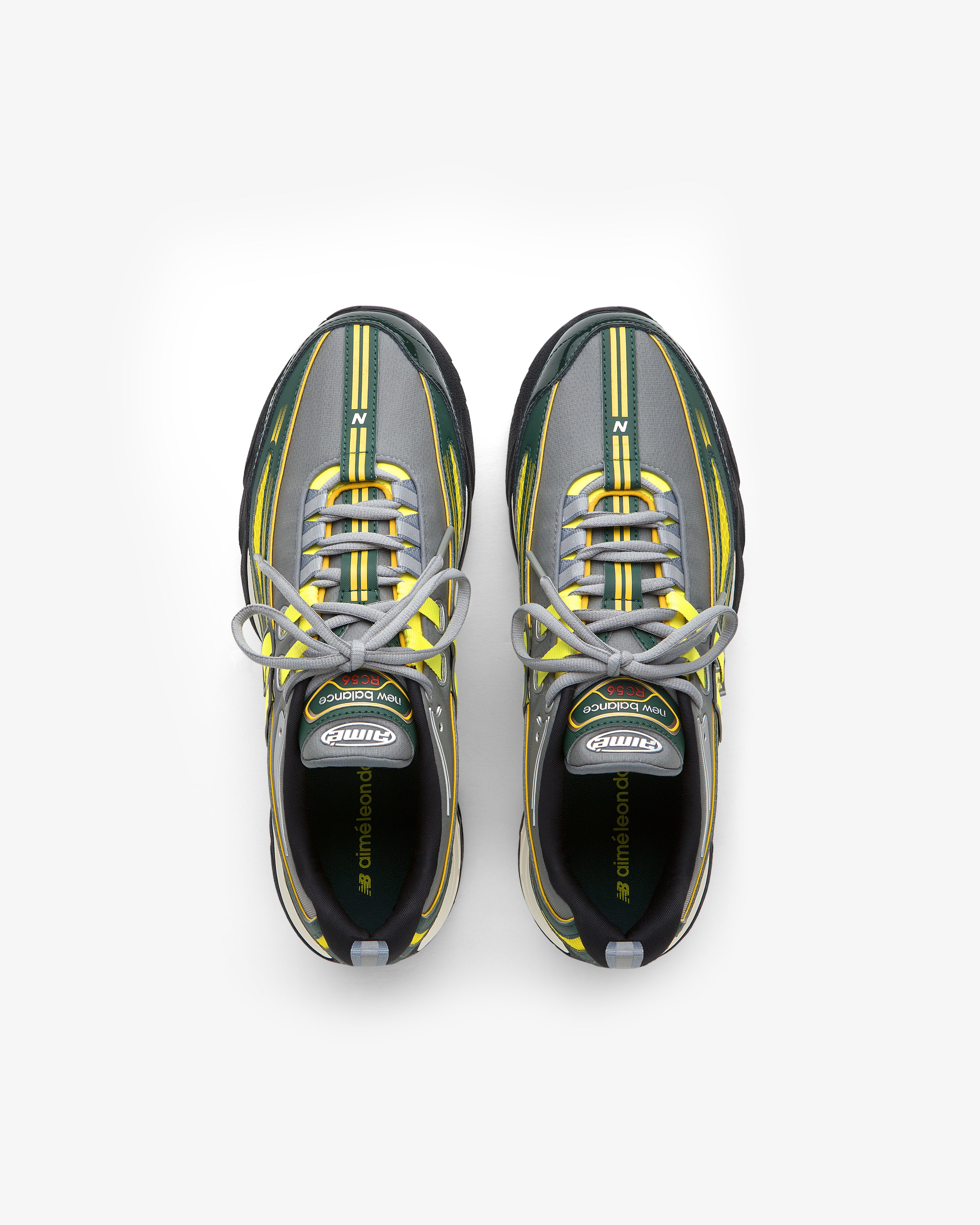 The ALD / New Balance RC56 sneakers in gray, black, and yellow with white laces, seen from above on white.