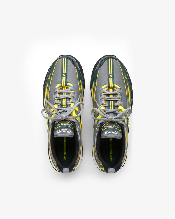 The ALD / New Balance RC56 sneakers in gray, black, and yellow with white laces, seen from above on white.