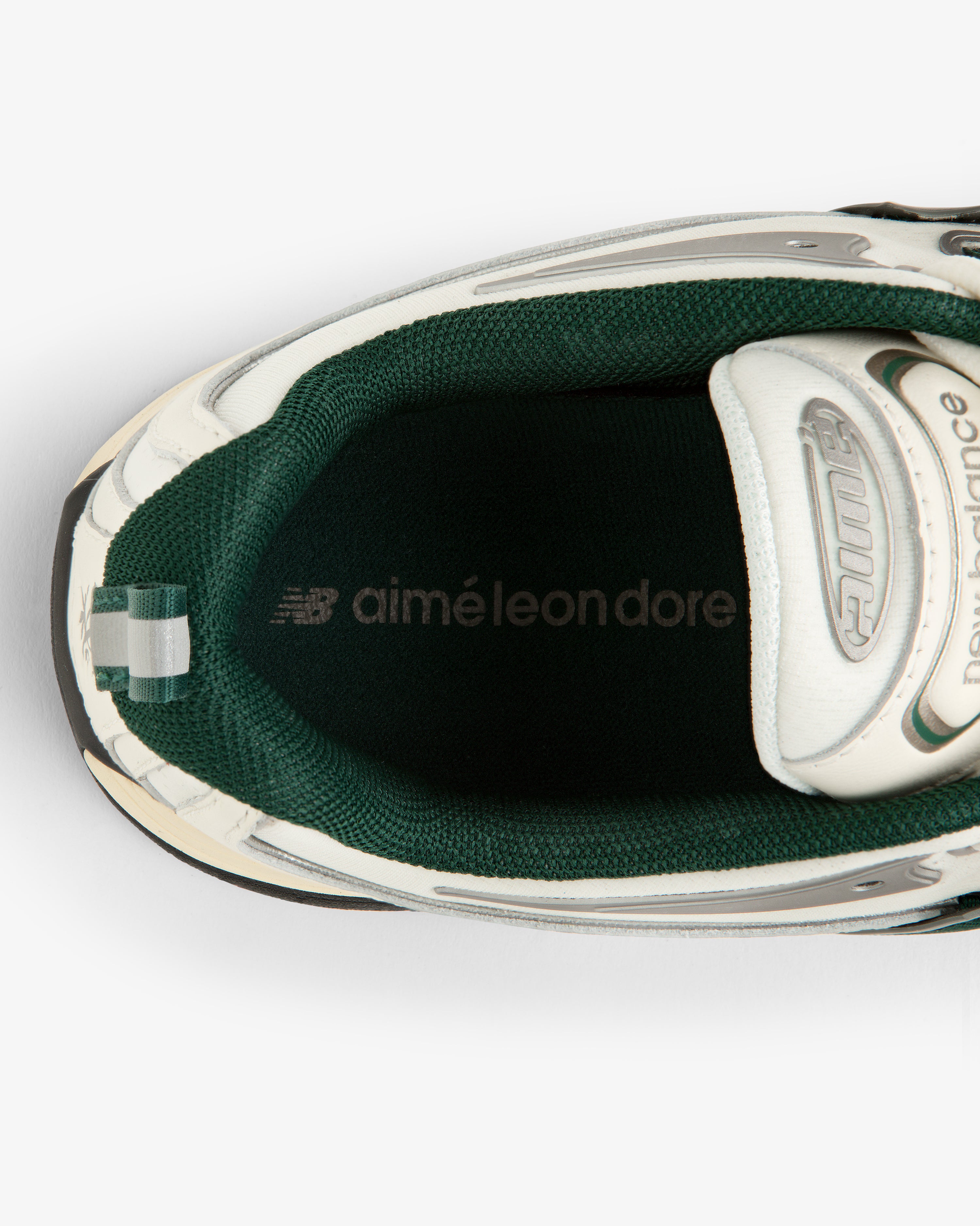 Top view of the ALD / New Balance RC56 sneaker in green and white with branding on the insole.