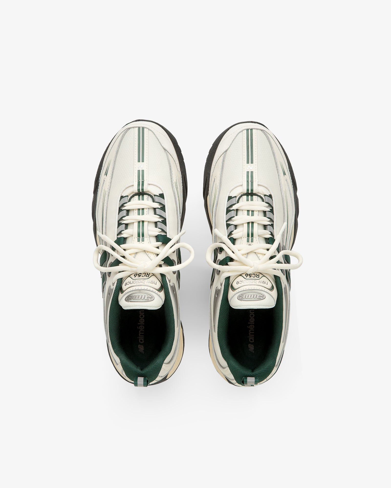 ALD / New Balance RC56 white sneakers with green stripes and black soles, viewed from above on a white background.