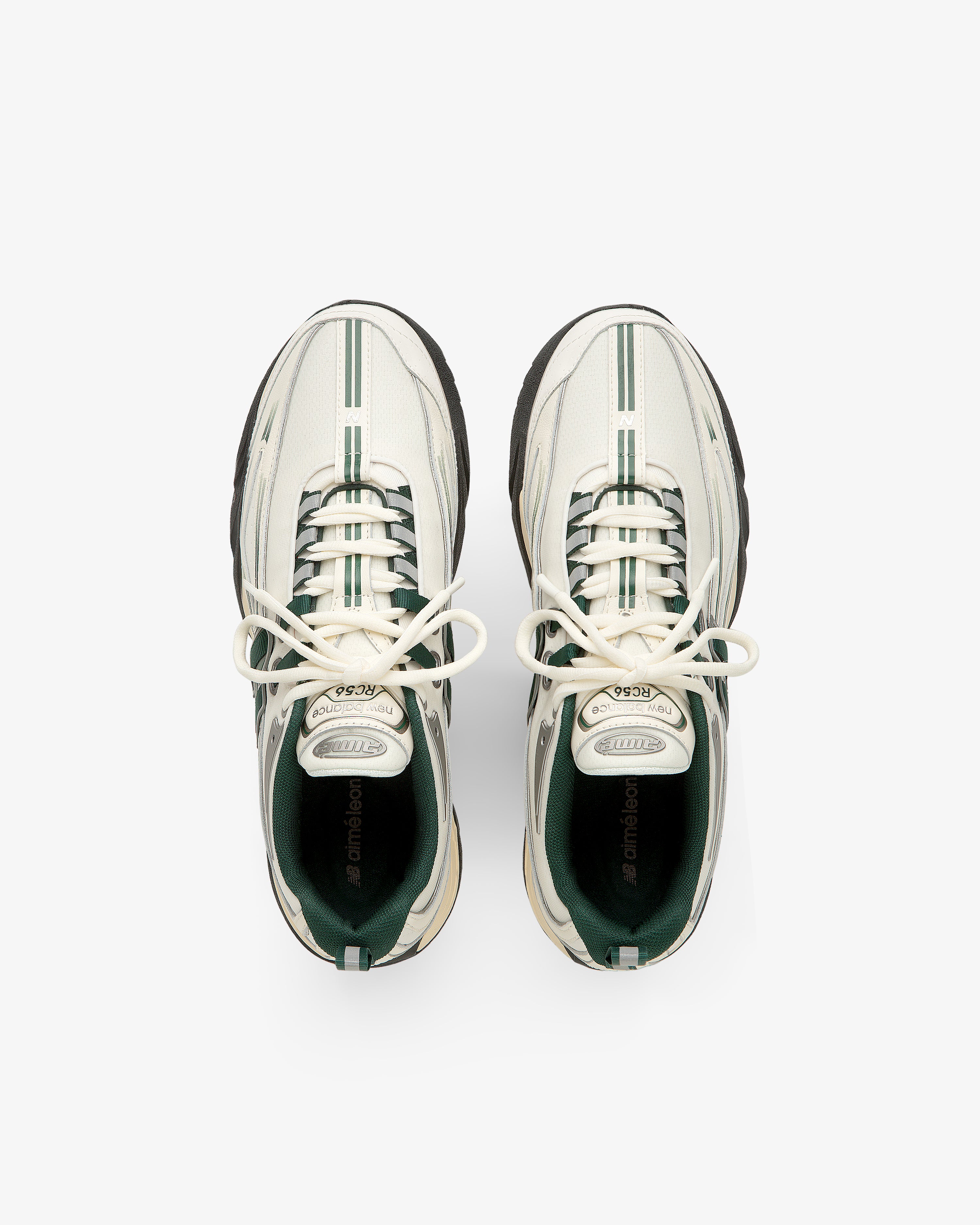 ALD / New Balance RC56 white sneakers with green stripes and black soles, viewed from above on a white background.