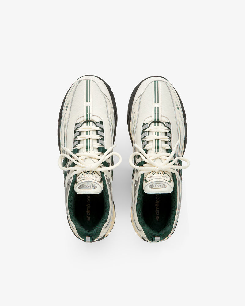 ALD / New Balance RC56 white sneakers with green stripes and black soles, viewed from above on a white background.